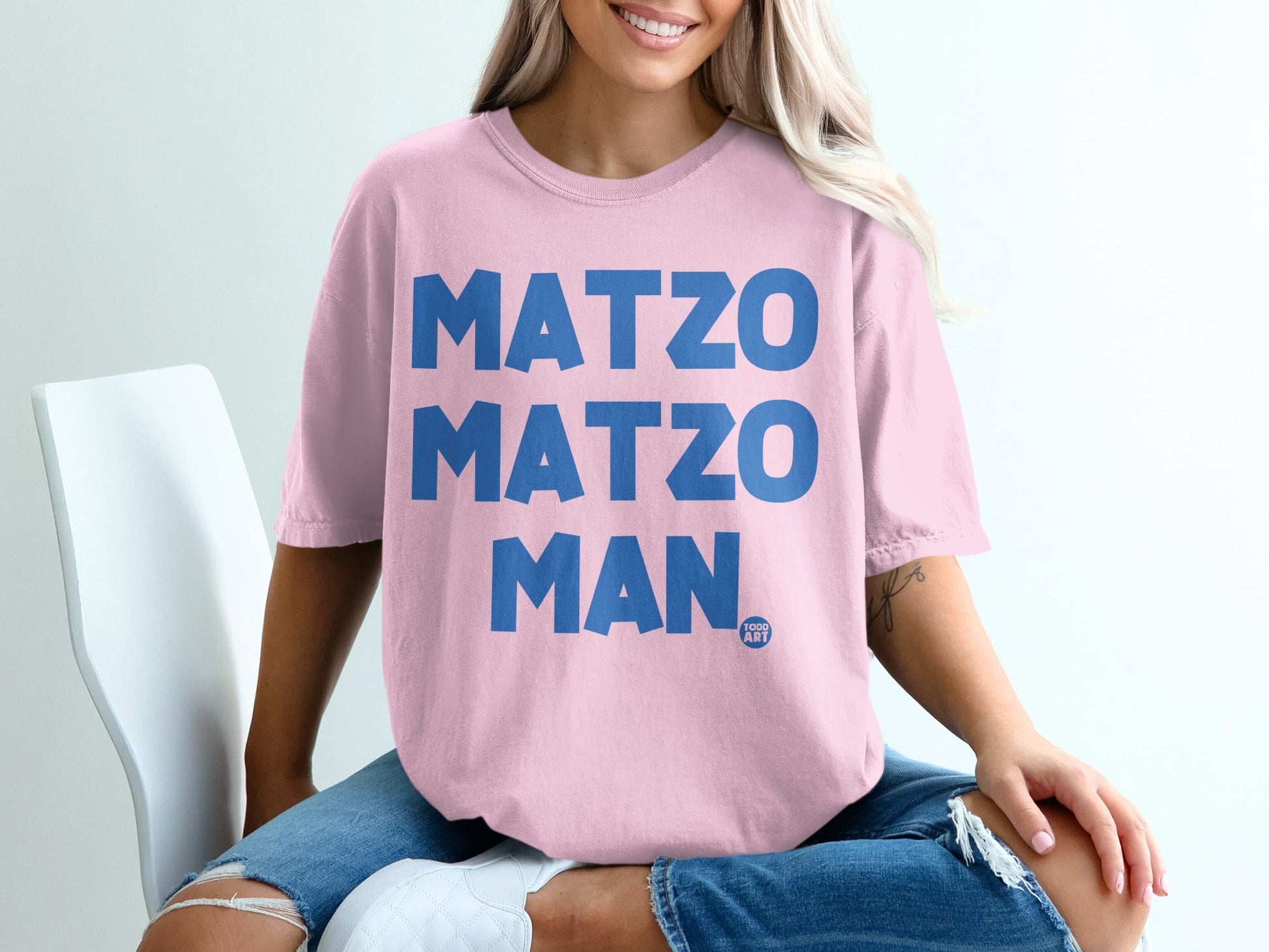 Pink t-shirt with "MATZO MATZO MAN" printed in blue letters.