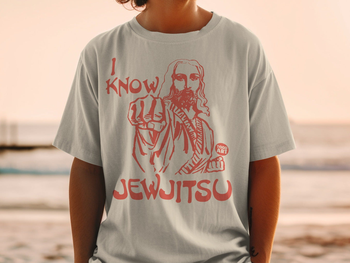 Light grey t-shirt with red graphic of Jesus pointing and text "I KNOW JEWJITSU".