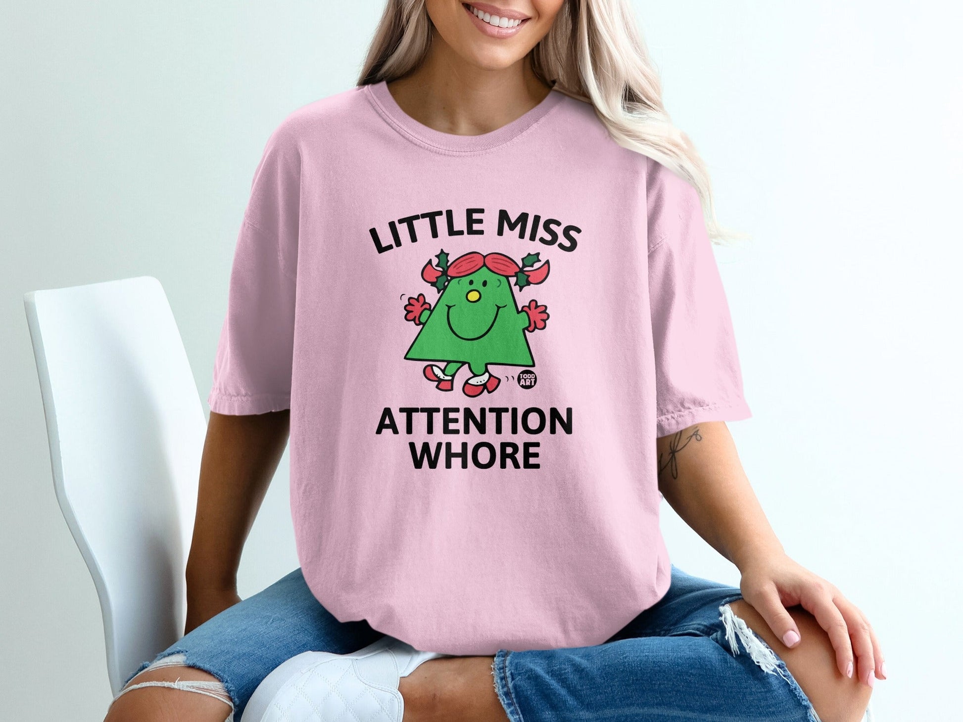 Pink t-shirt with "Little Miss Attention Whore" and a cartoon character.