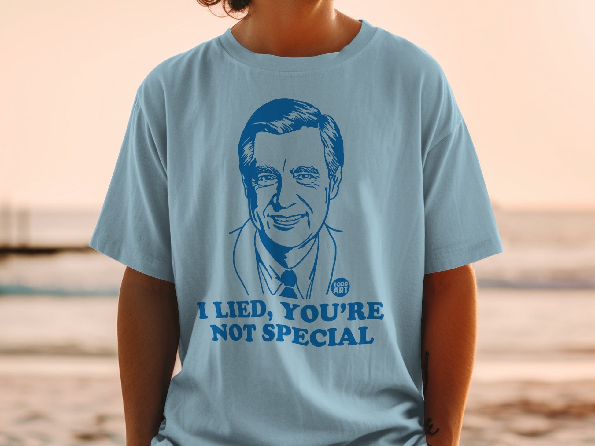 Light blue t-shirt with a blue graphic of Fred Rogers and text "I LIED, YOU'RE NOT SPECIAL".