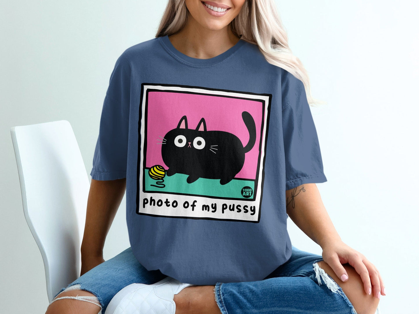 Black cat playing with yarn, text "photo of my pussy".