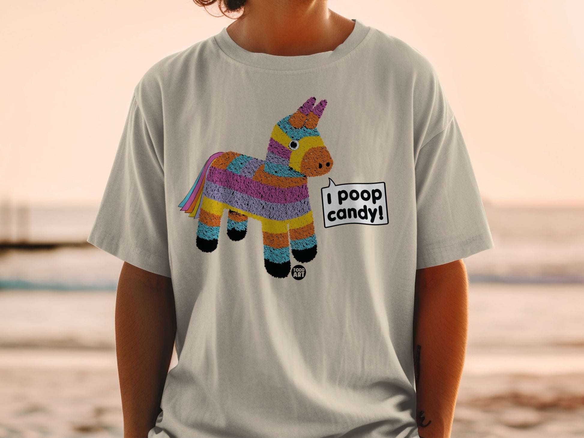 T-shirt with a colorful pinata graphic and text bubble saying "I poop candy".