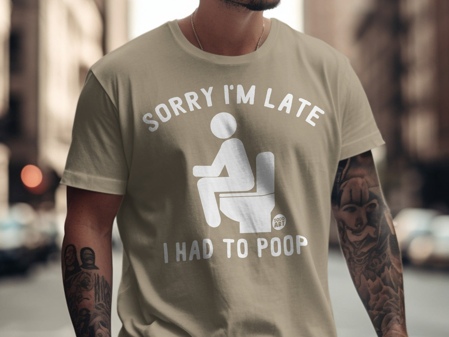 Khaki t-shirt with white text and graphic: "Sorry I'm Late I Had to Poop".