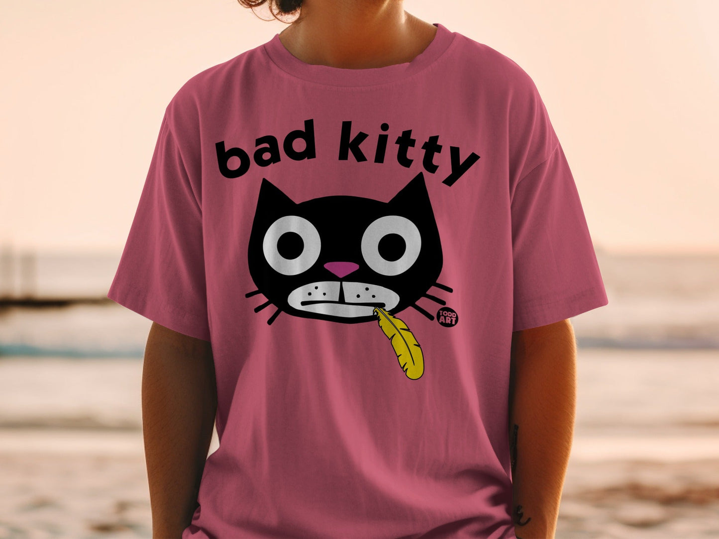 Bad Kitty Graphic Tee with Cartoon Cat and Feather Design