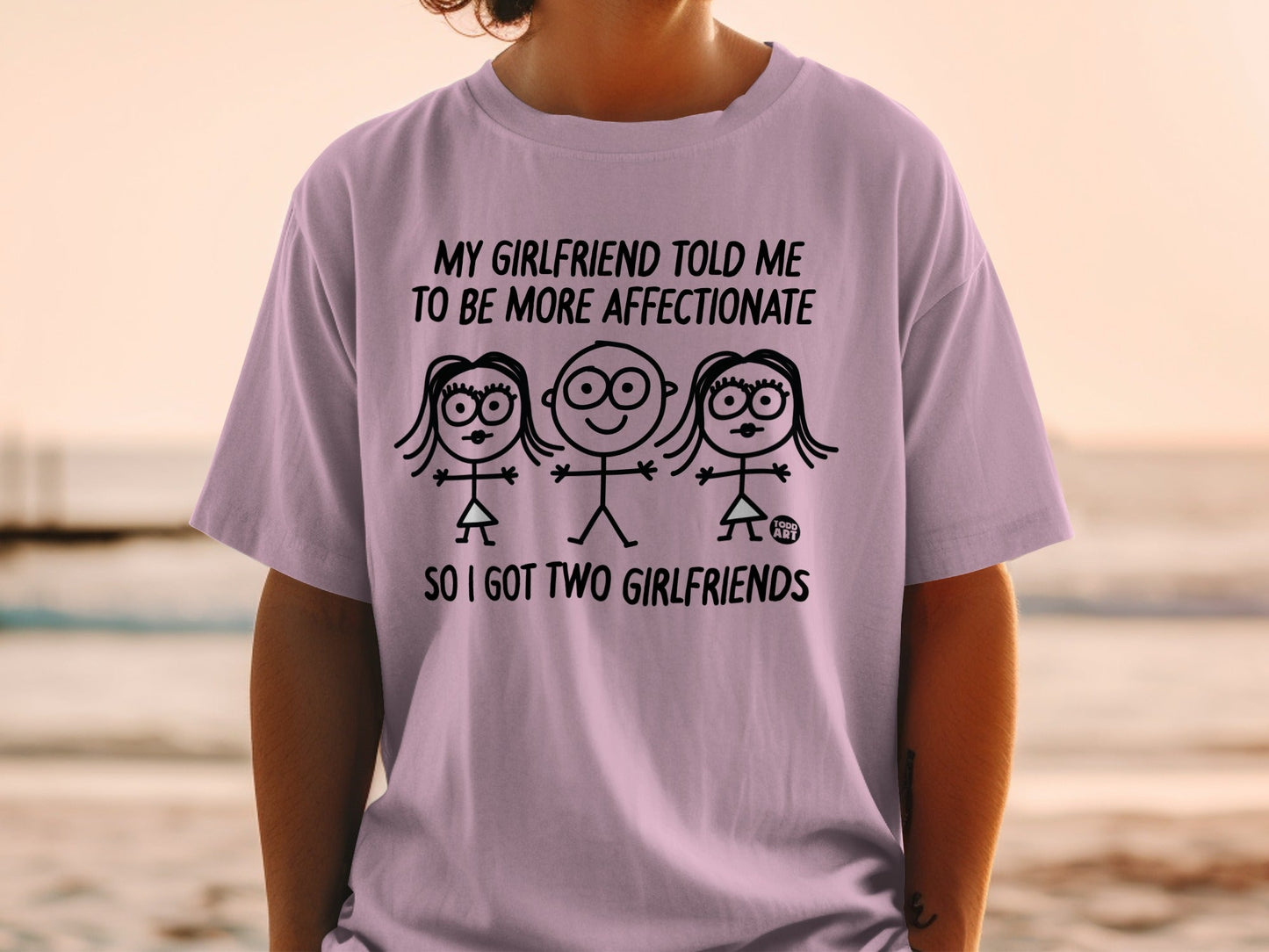 T-shirt with stick figures and text about having two girlfriends.