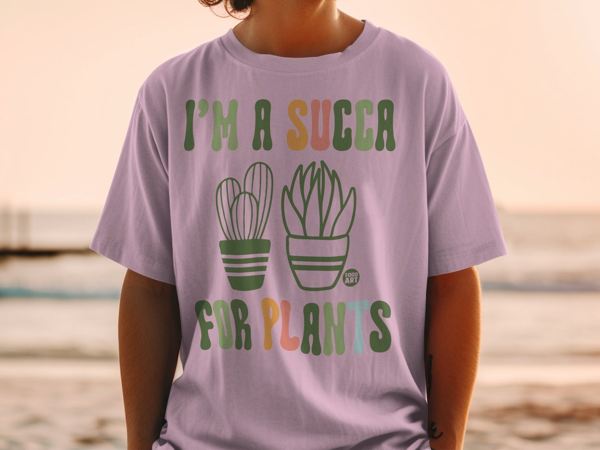 T-shirt with "I'm a succa for plants" text and cartoon cacti.