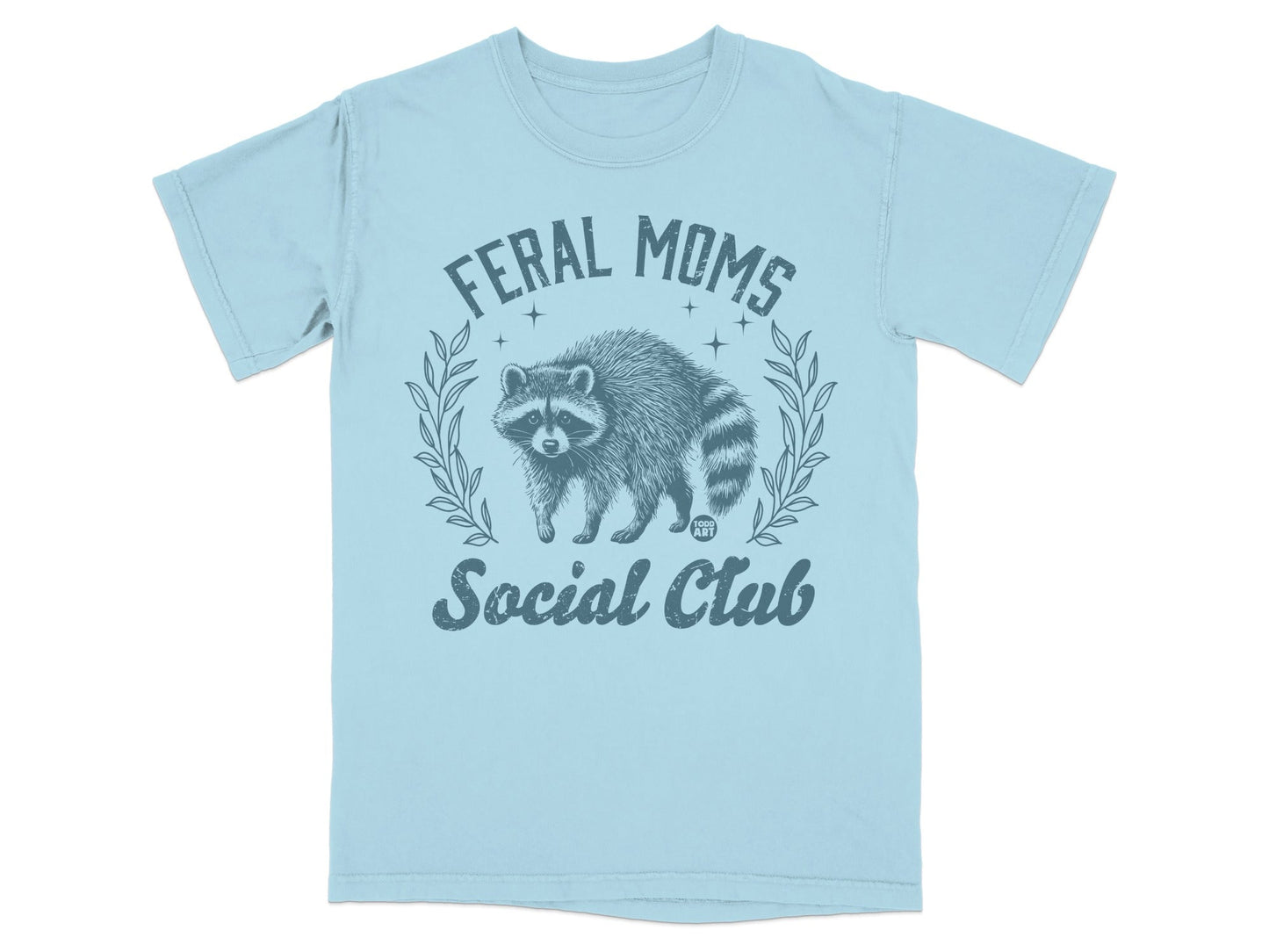 Light blue t-shirt with a distressed graphic of a raccoon and "Feral Moms Social Club" text.