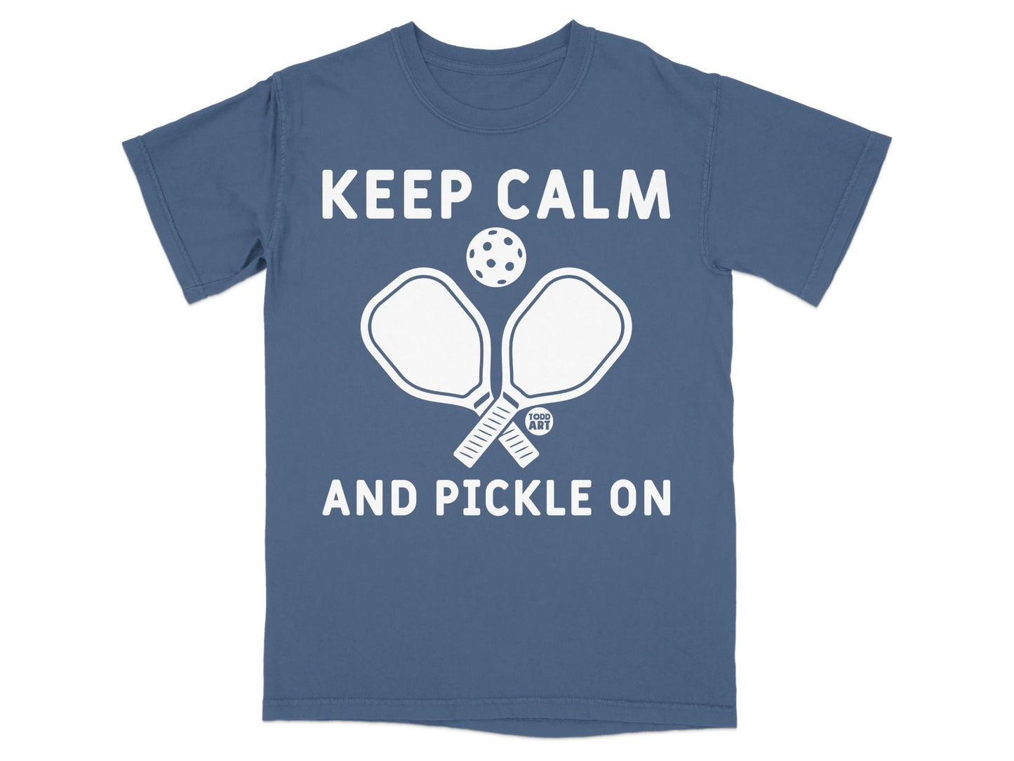 Blue t-shirt with "Keep Calm and Pickle On" and pickleball paddles.