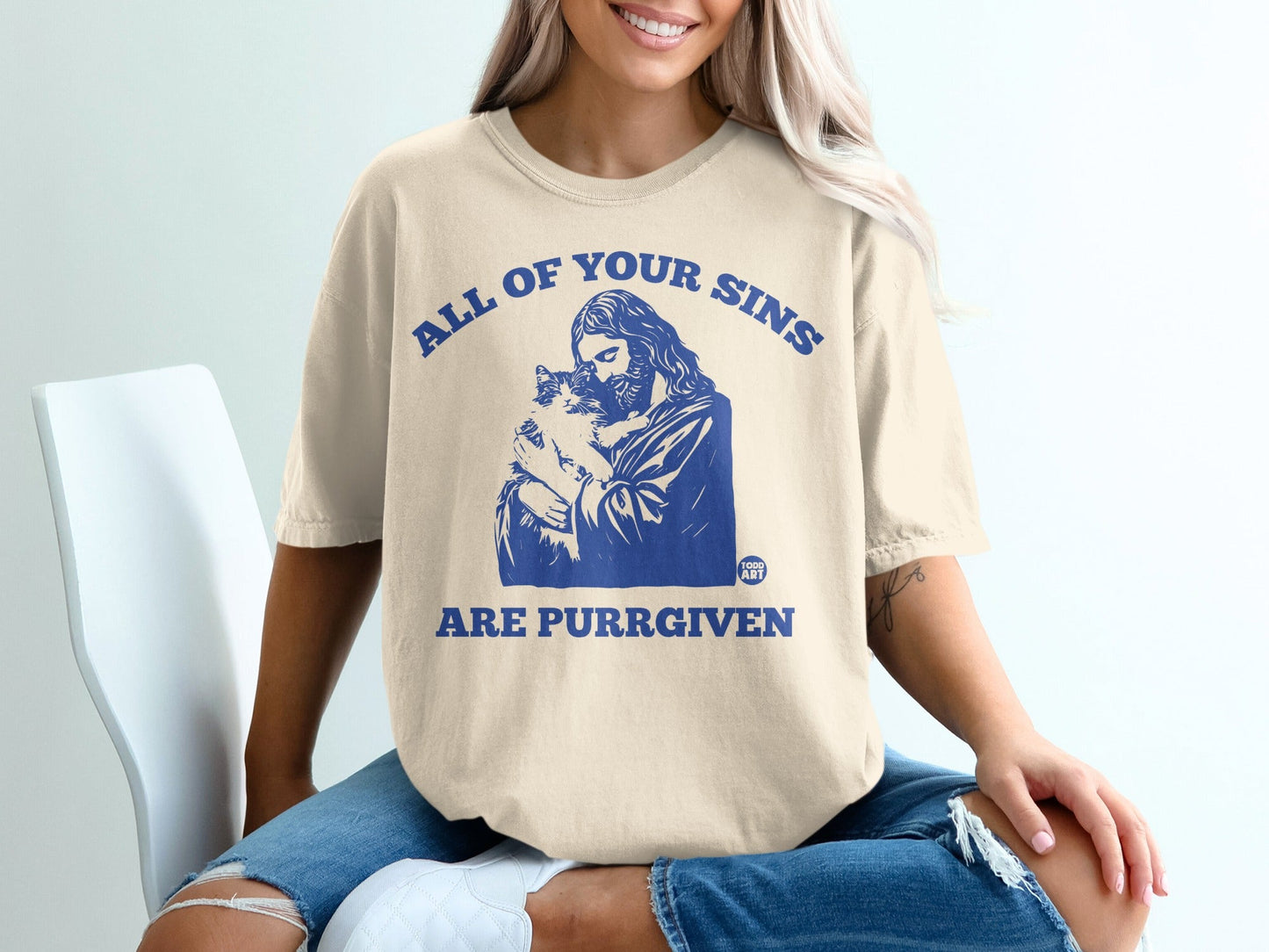 T-shirt with Jesus holding a cat, text "All of your sins are purrgiven".