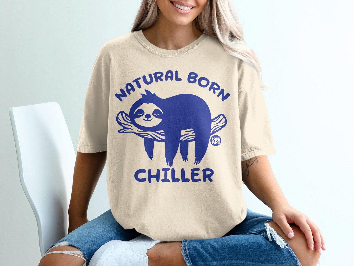 Cream t-shirt with blue sloth graphic and text "NATURAL BORN CHILLER".