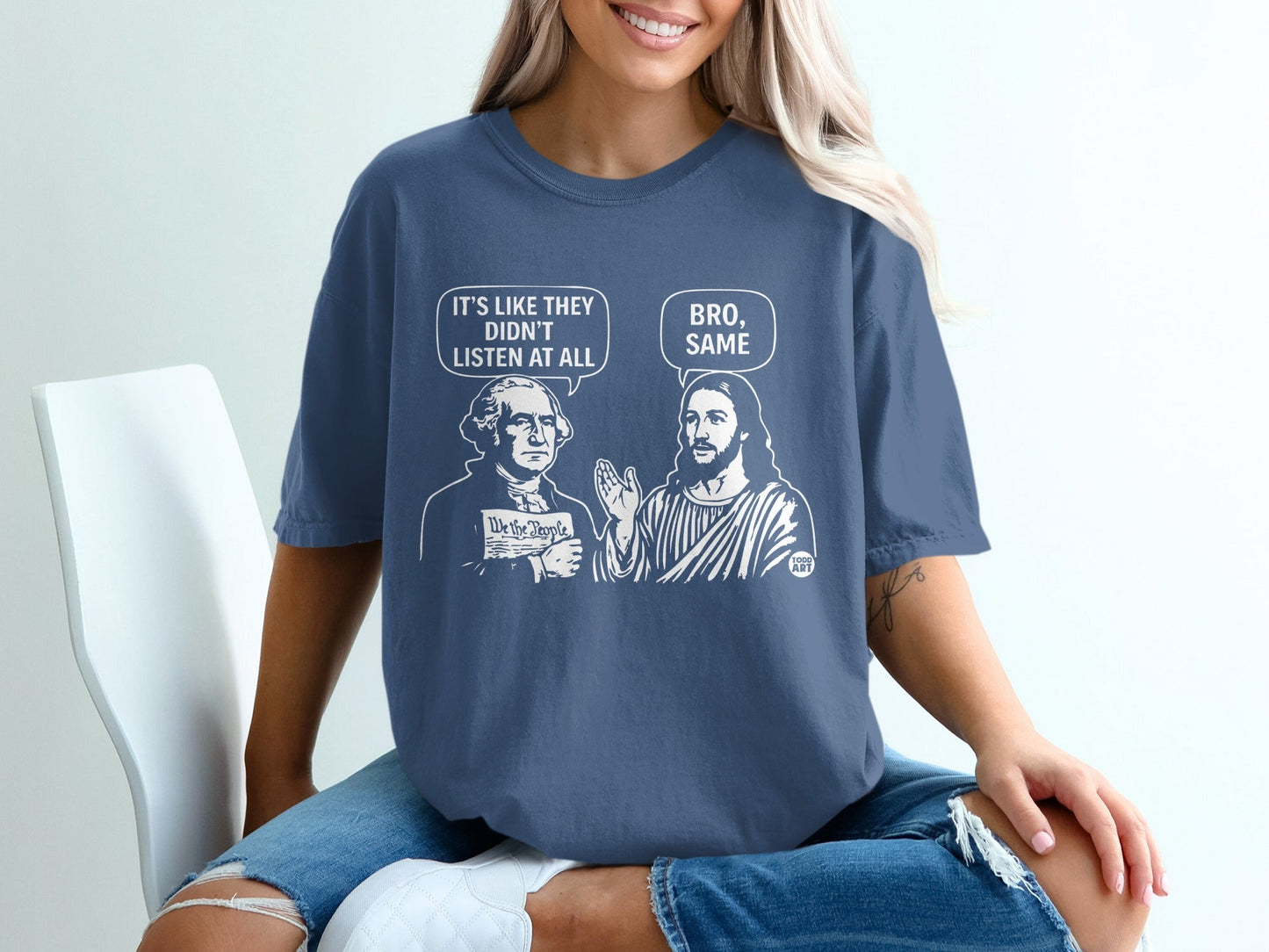 George Washington and Jesus discuss "We the People" on a blue t-shirt.