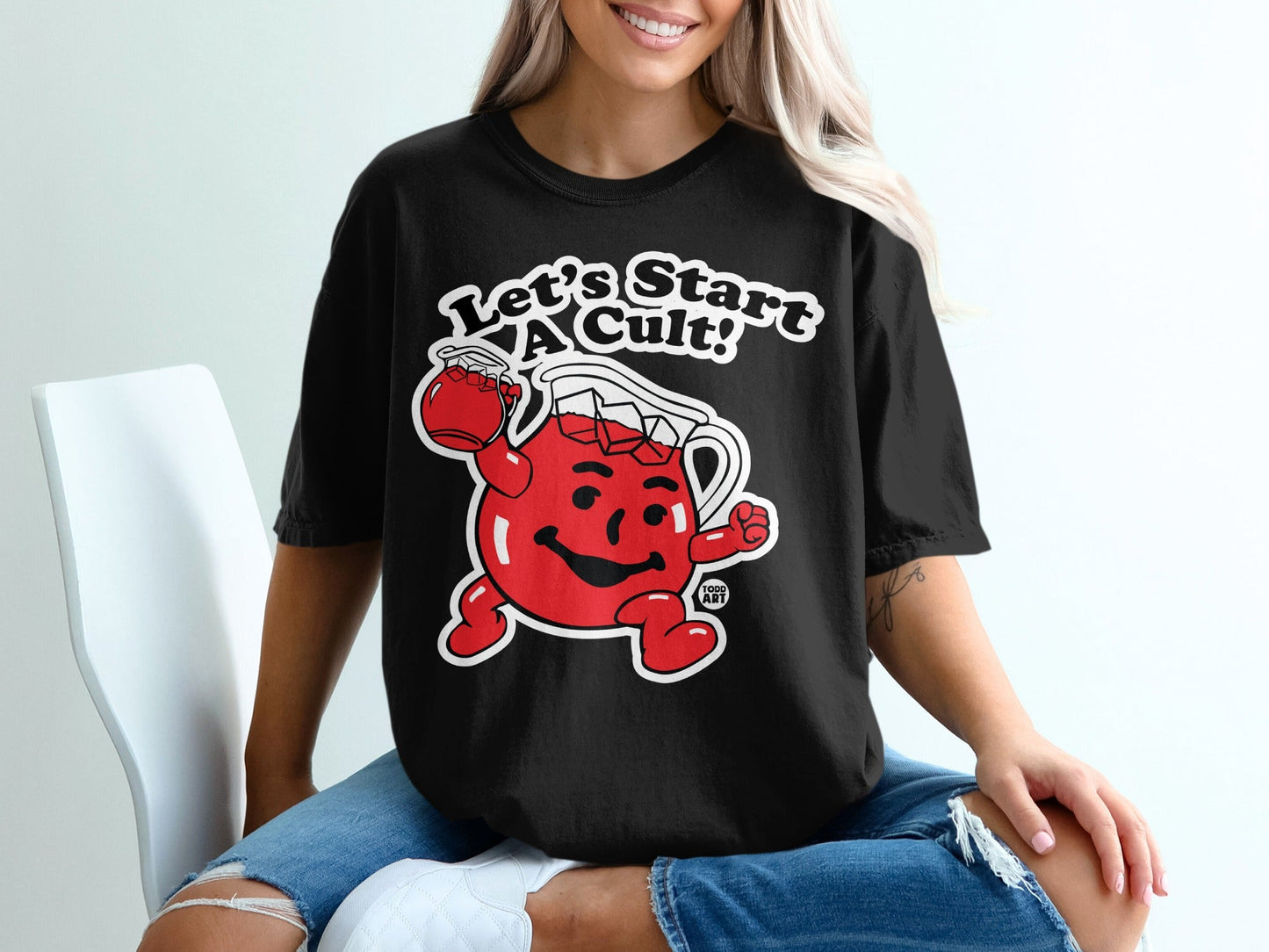 Black t-shirt with Kool-Aid Man saying "Let's Start A Cult!"