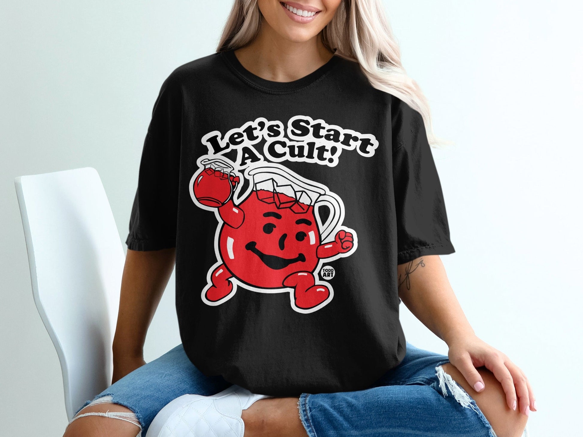 Black t-shirt with Kool-Aid Man saying "Let's Start A Cult!"