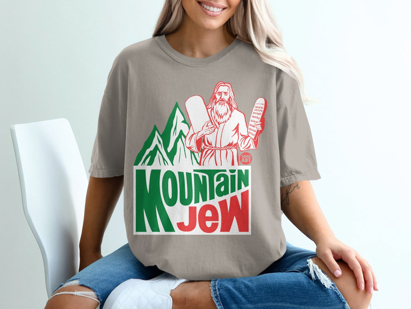 T-shirt with "Mountain Jew" text, mountains, and a figure holding tablets.
