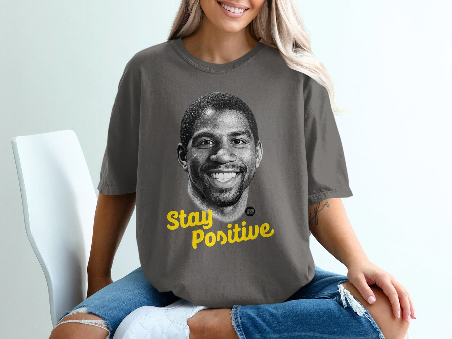 T-shirt with portrait of Magic Johnson and "Stay Positive" text.