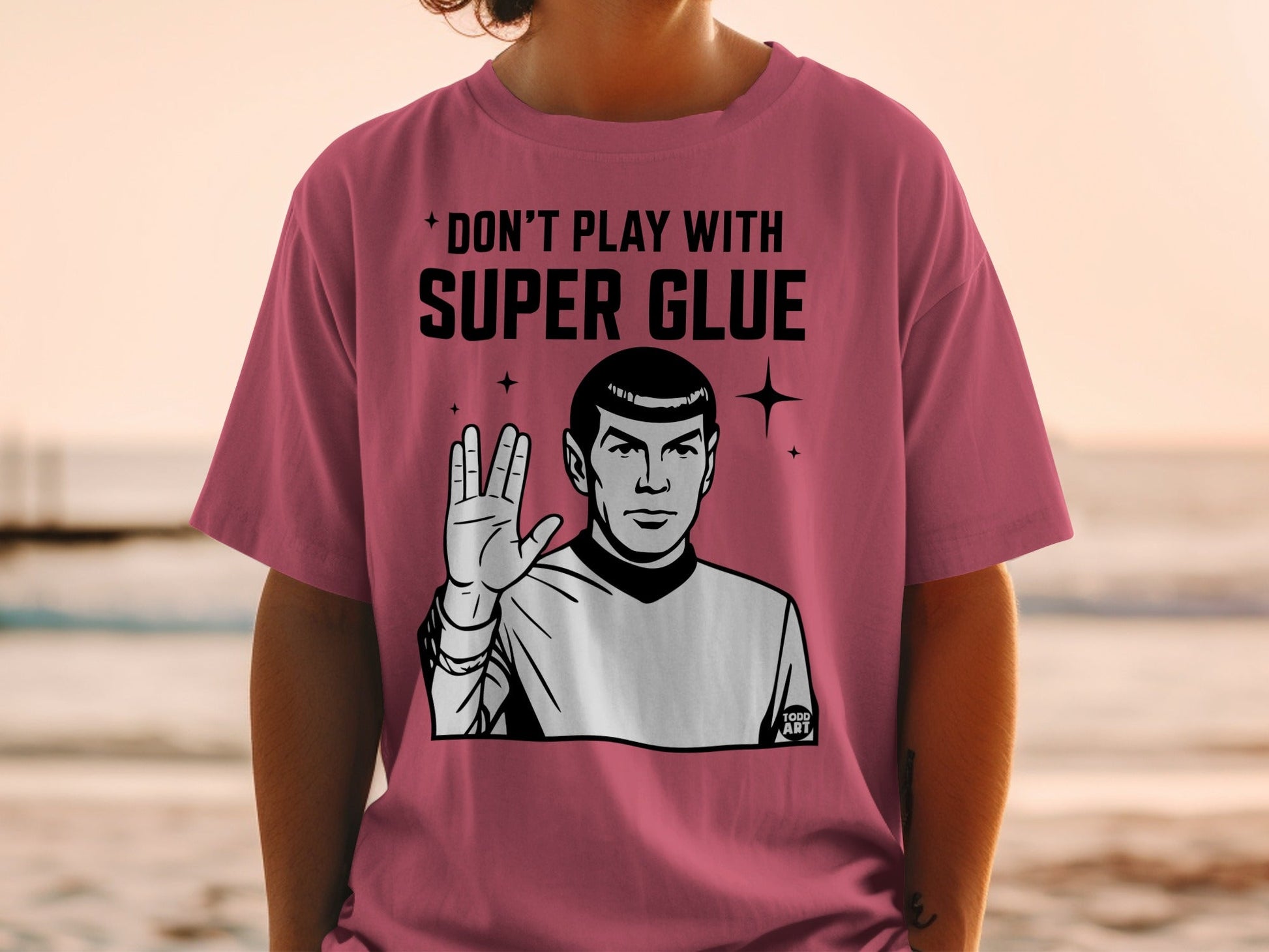 Spock wearing a pink t-shirt with "DON'T PLAY WITH SUPER GLUE" text.