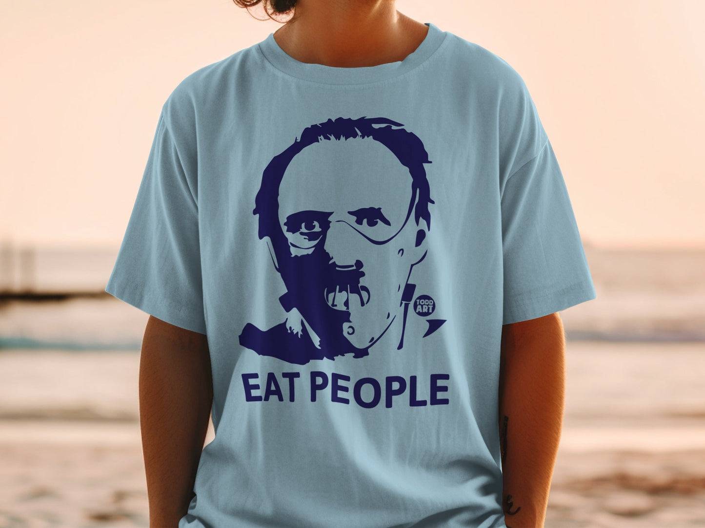 Light blue t-shirt with dark blue graphic of a face and "EAT PEOPLE" text.