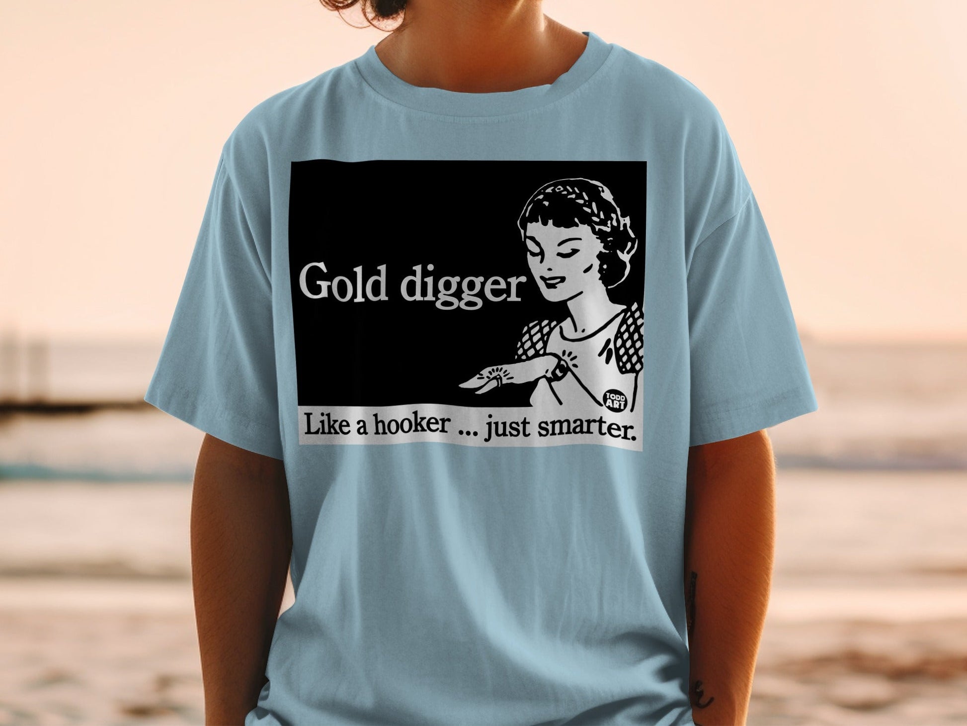 Light blue t-shirt with "Gold Digger Like a hooker... just smarter." text and illustration.