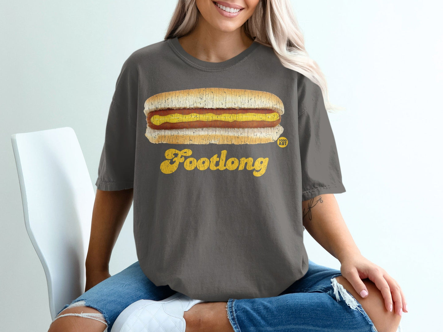 Dark grey t-shirt with yellow "Footlong" text and a hot dog graphic.