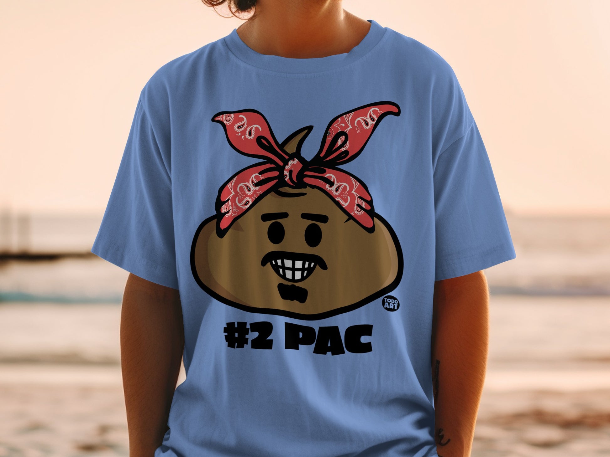 Blue t-shirt with a brown character wearing a red bandana, smiling.