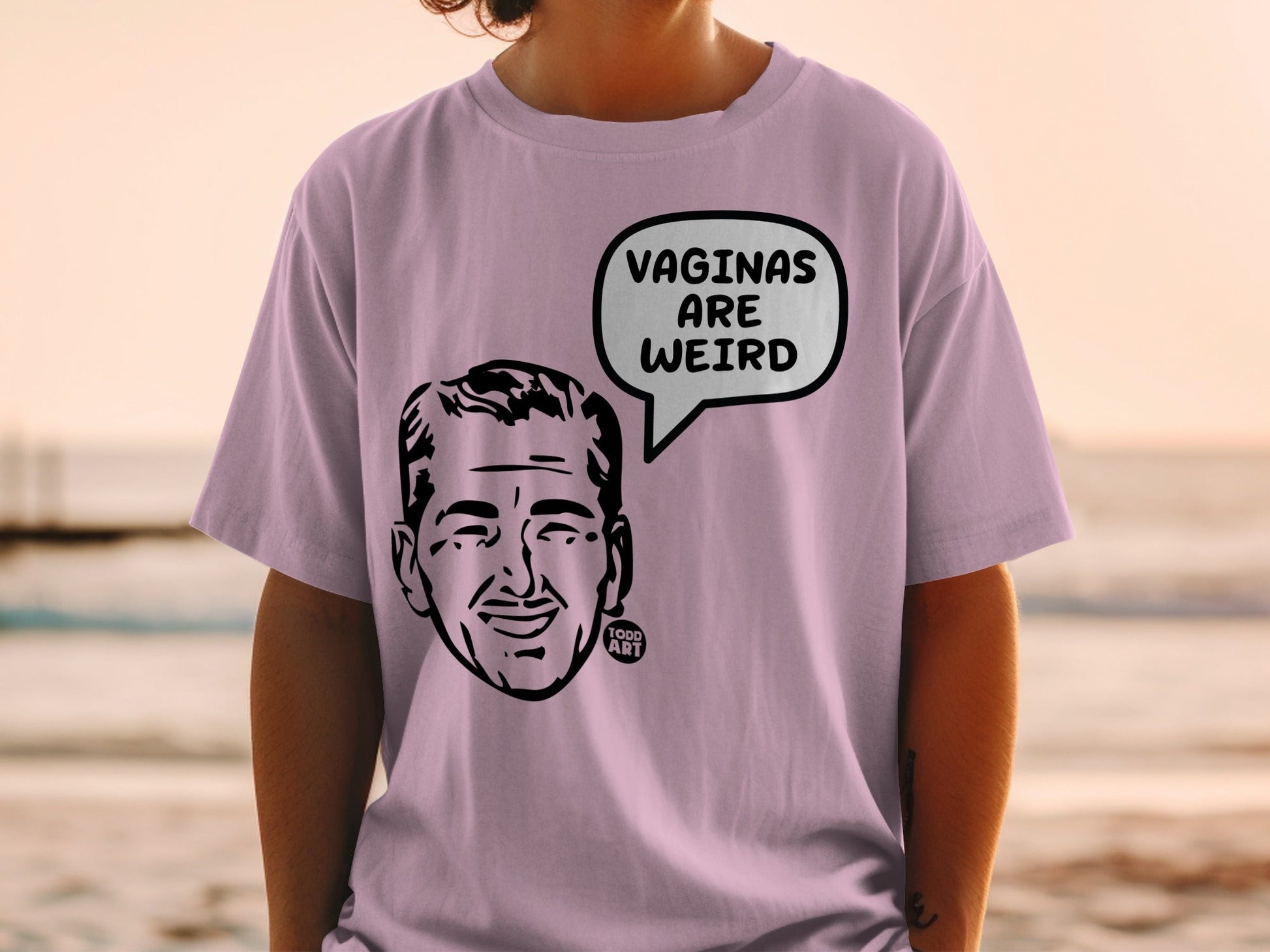 Lavender t-shirt with cartoon face and "VAGINAS ARE WEIRD" speech bubble.