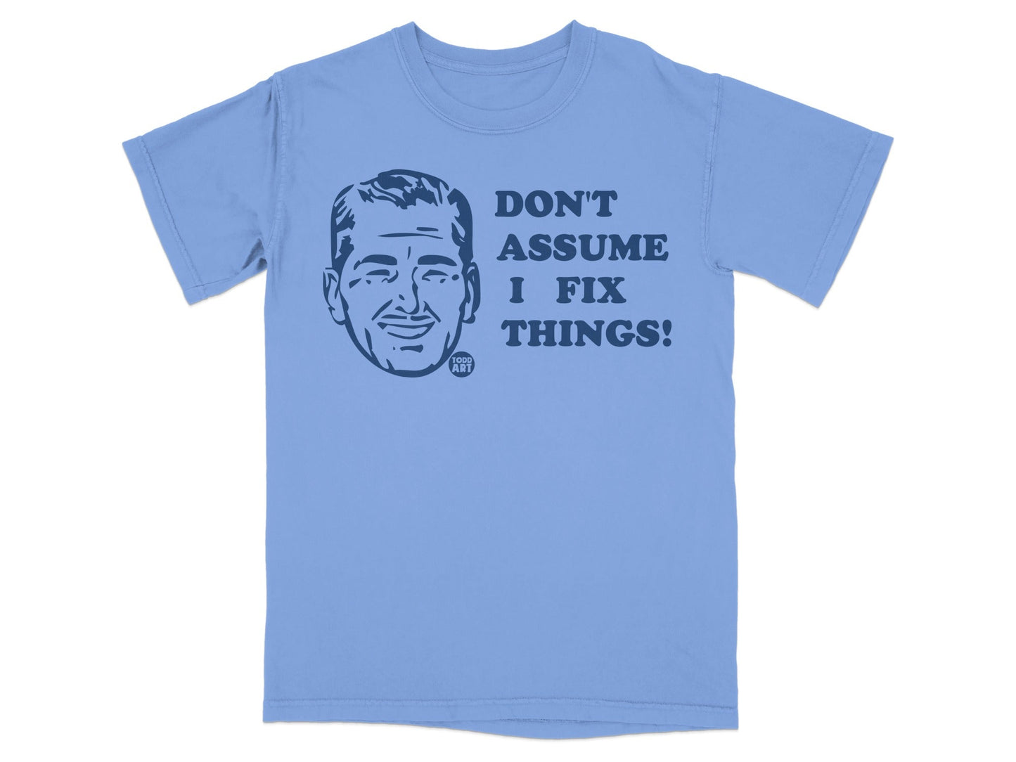 Light blue t-shirt with a graphic of a man's head and text "DON'T ASSUME I FIX THINGS!".