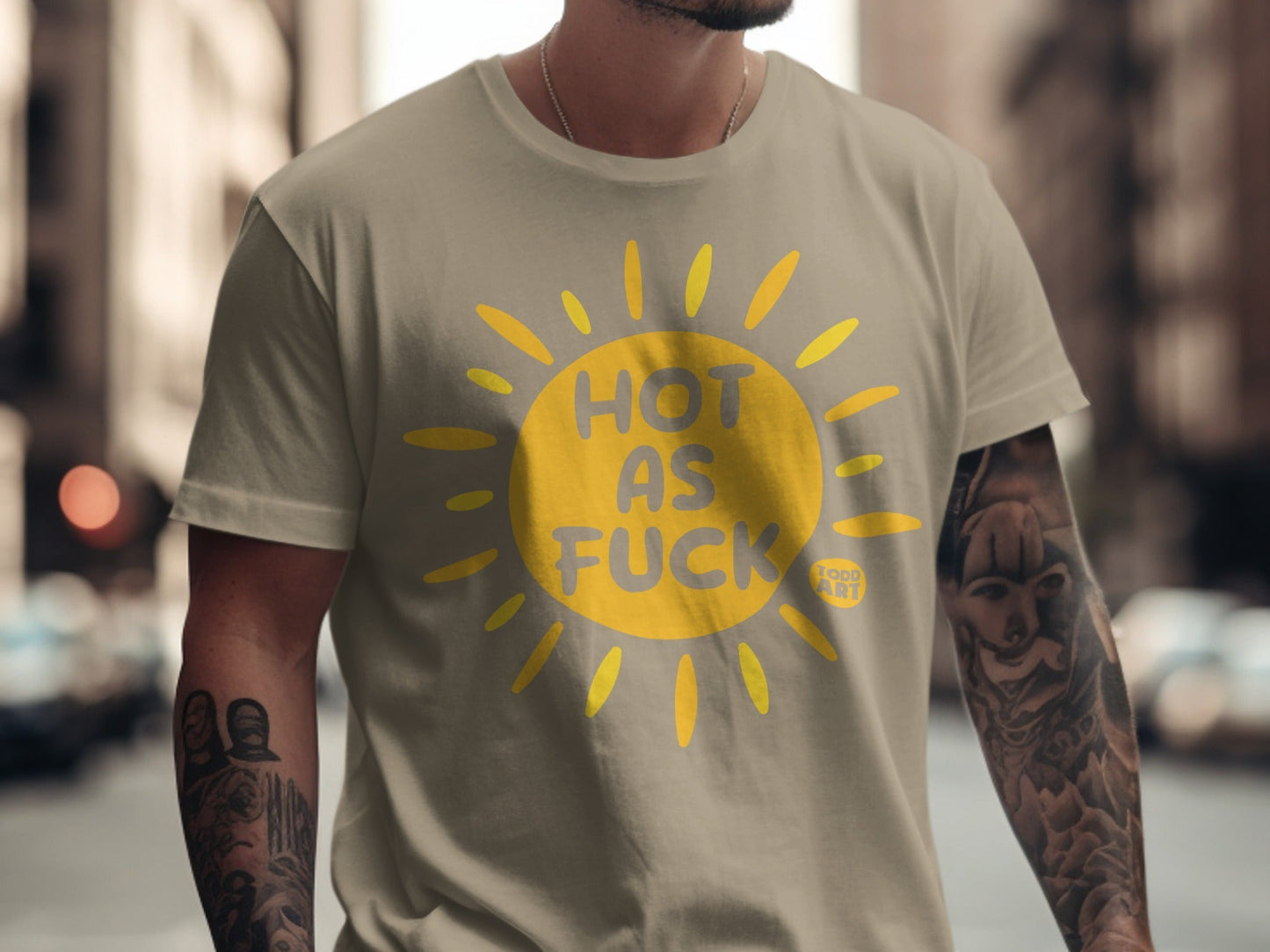Tan t-shirt with yellow sun graphic and "HOT AS FUCK" text.