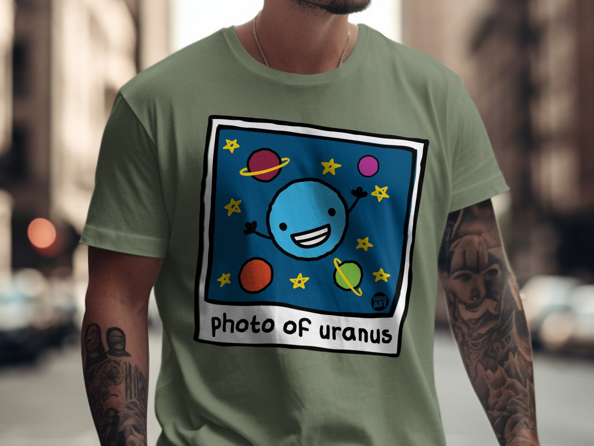 T-shirt with a cartoon blue planet in a polaroid frame.