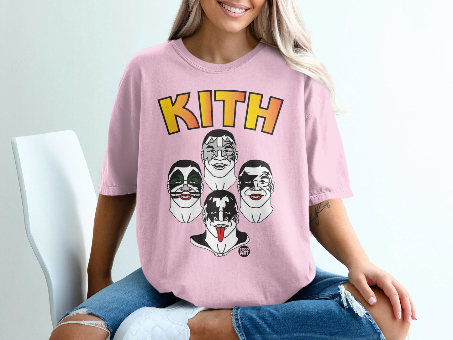 Pink t-shirt featuring the KITH logo and cartoon faces of KISS band members.