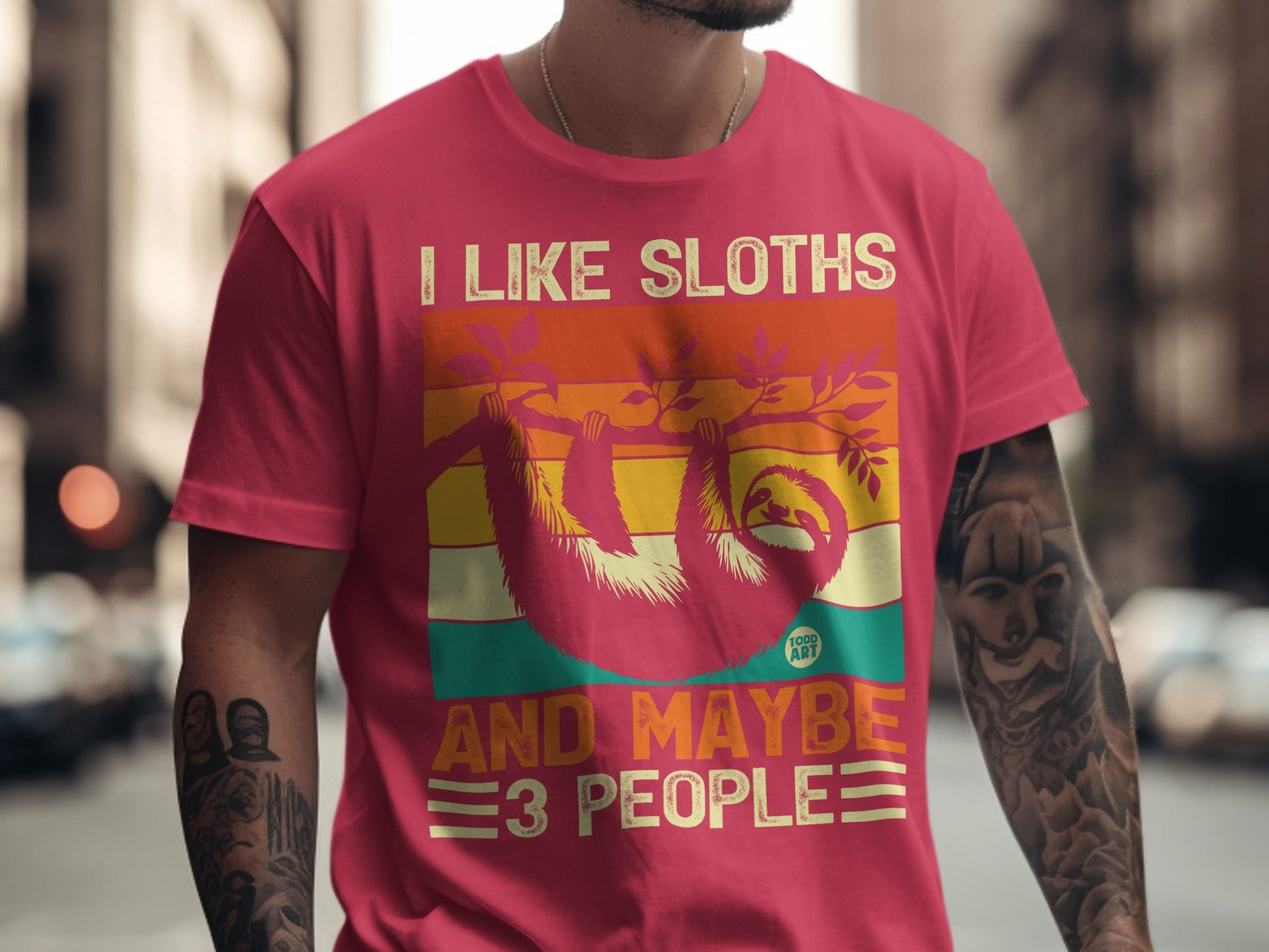 T-shirt with pink, orange, and green stripes, featuring a sloth.