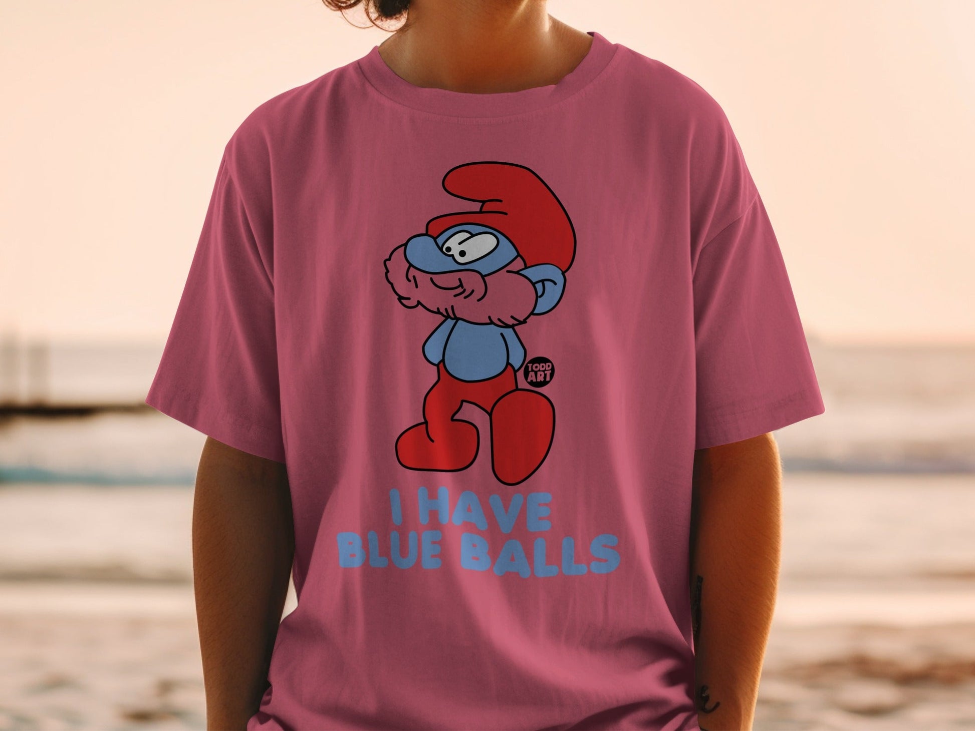 Smurf character on pink t-shirt with "I HAVE BLUE BALLS" text.