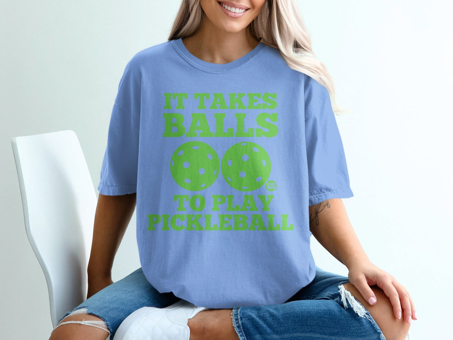 Light blue t-shirt with green text and pickleball graphics.