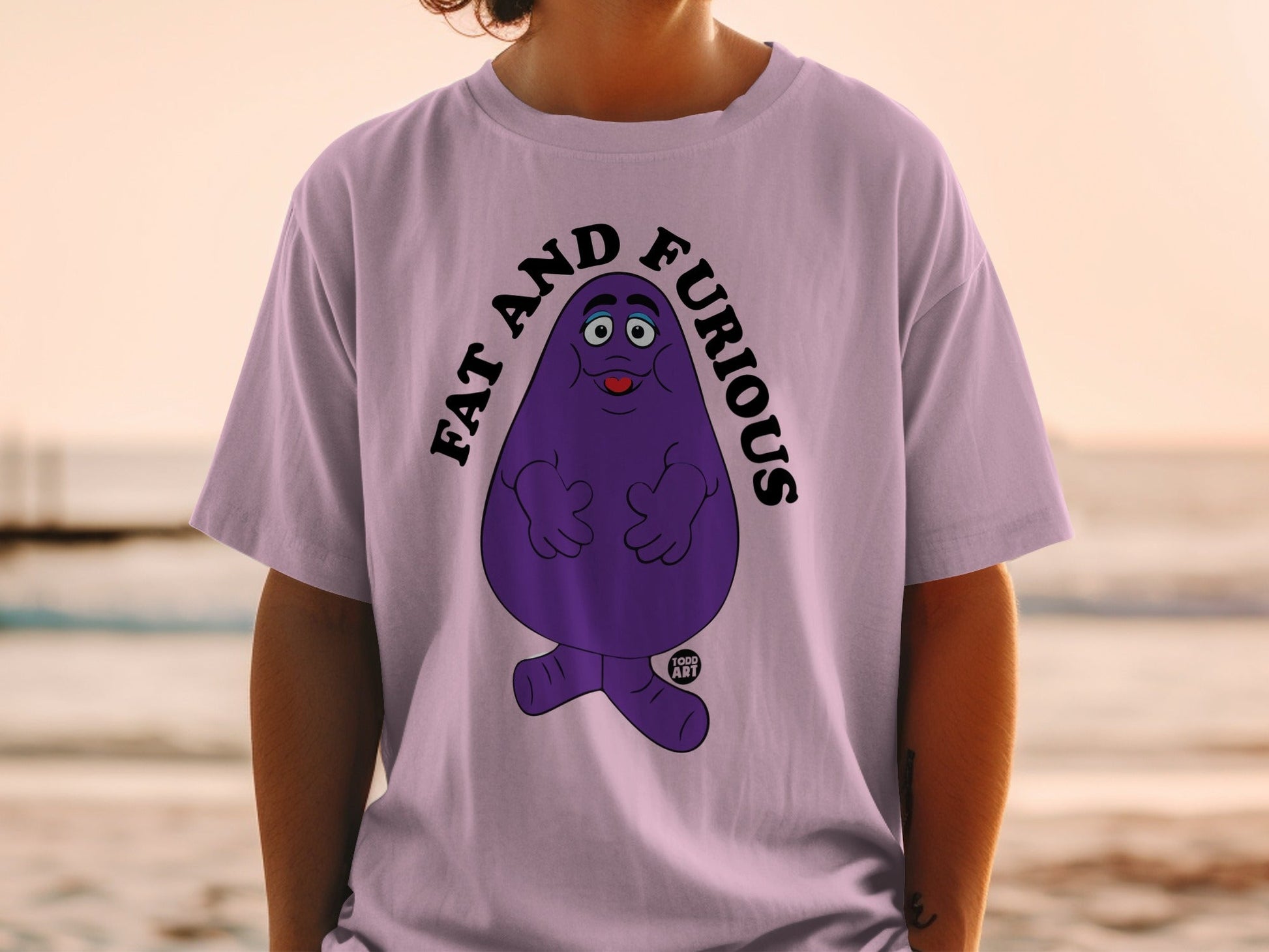 Purple character with "FAT AND FURIOUS" text on a light purple t-shirt.