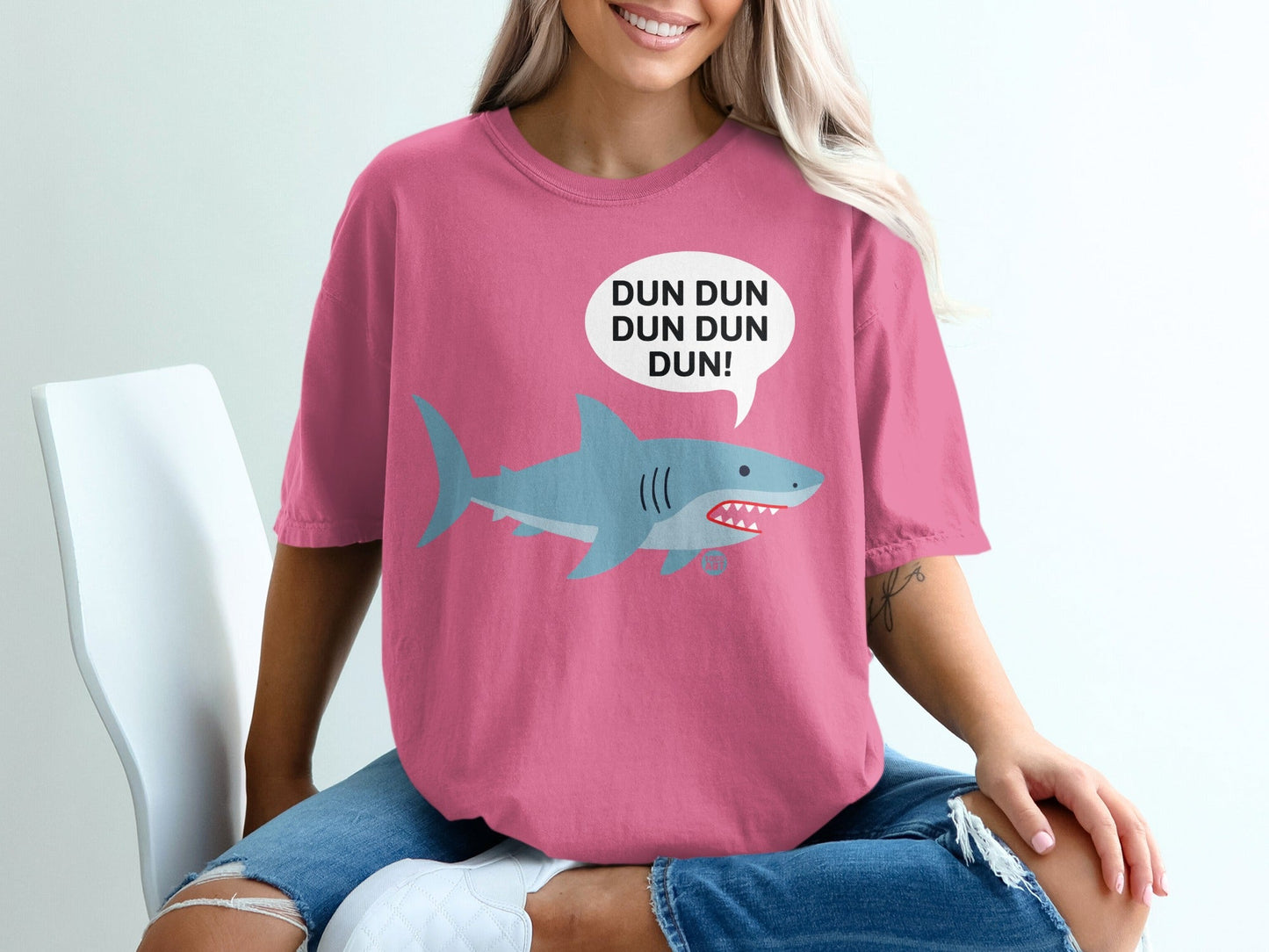 Pink t-shirt with a cartoon shark and "DUN DUN DUN DUN!" speech bubble.