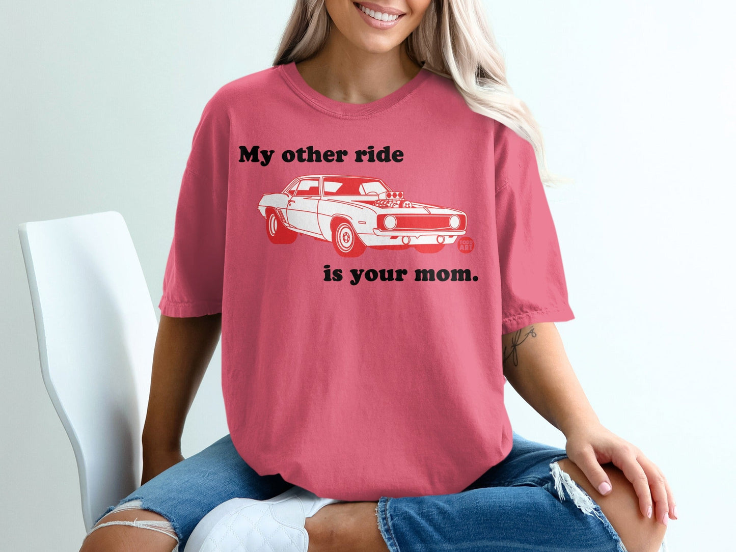 Pink t-shirt with a white graphic of a vintage car and text.