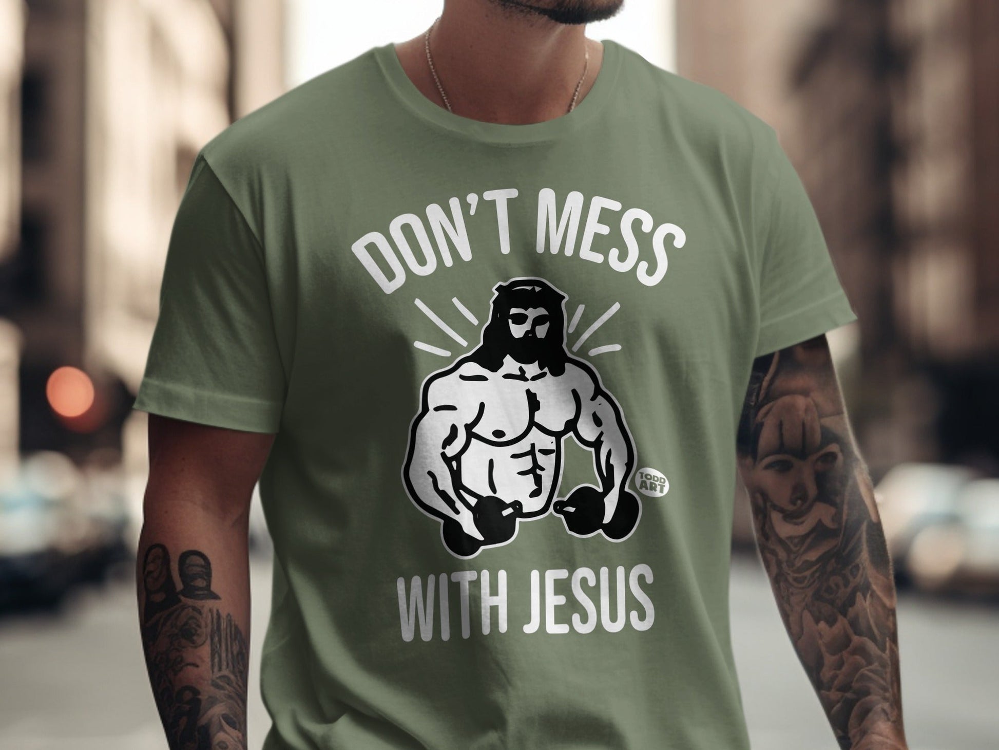 Green t-shirt with "Don't Mess With Jesus" and muscular Jesus graphic.