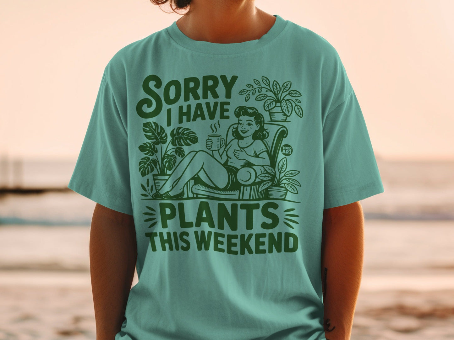 "Sorry I Have Plants This Weekend" text on a t-shirt with a woman and plants.