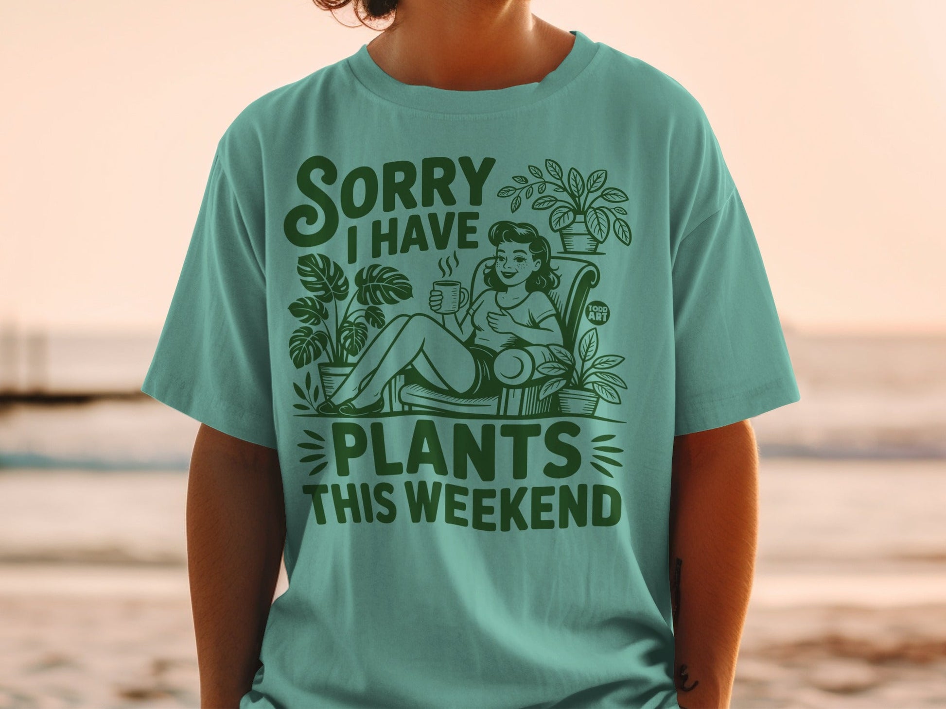 "Sorry I Have Plants This Weekend" text on a t-shirt with a woman and plants.