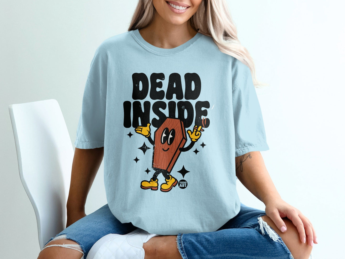 Light blue t-shirt with "DEAD INSIDE" text and cartoon coffin character.