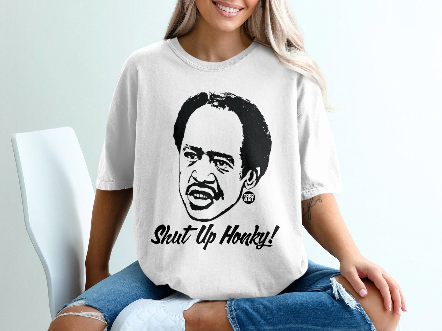 T-shirt with black and white portrait of Redd Foxx, text "Shut Up Honky!".