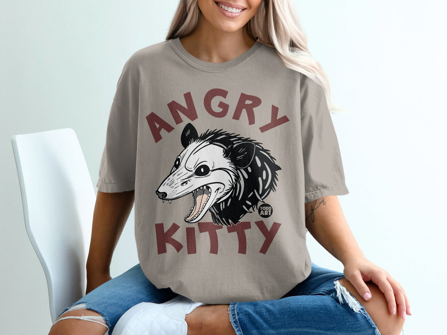 T-shirt with cartoon opossum graphic and "ANGRY KITTY" text.