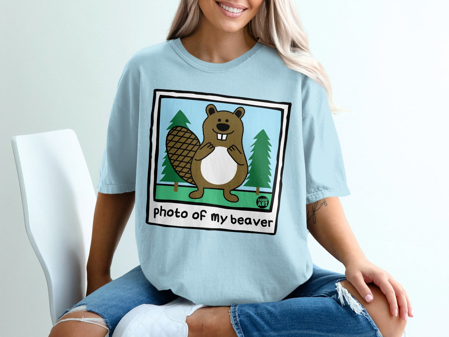 Cartoon beaver in a framed picture with trees, text reads "photo of my beaver".