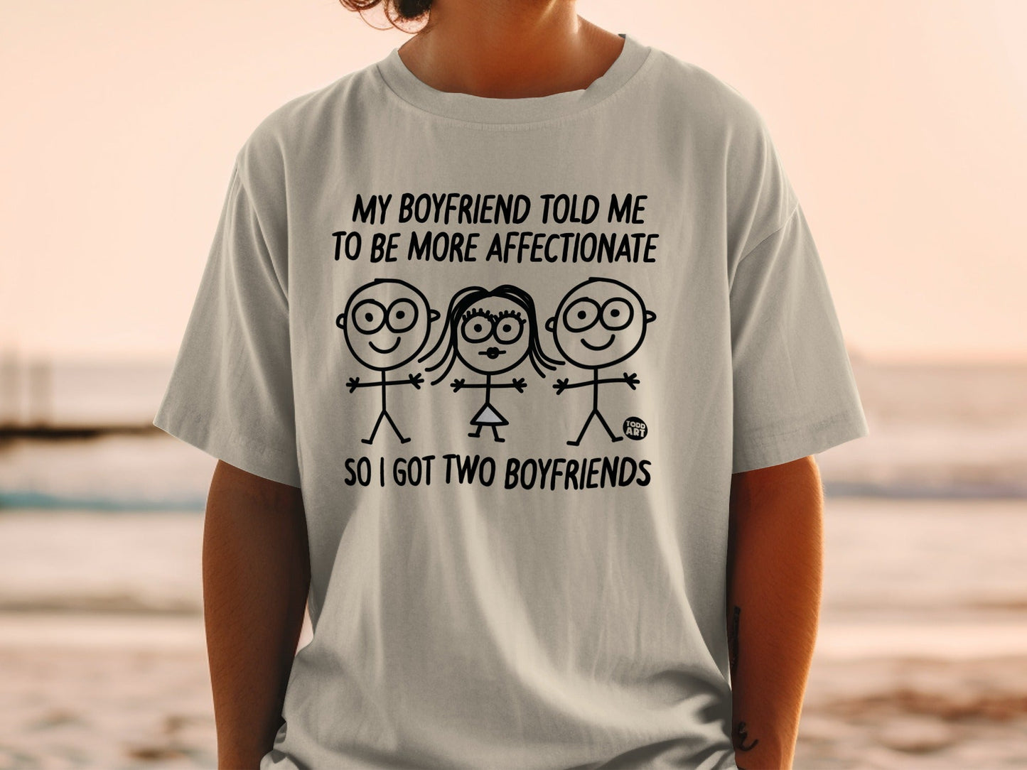 T-shirt with stick figures and text about having two boyfriends.