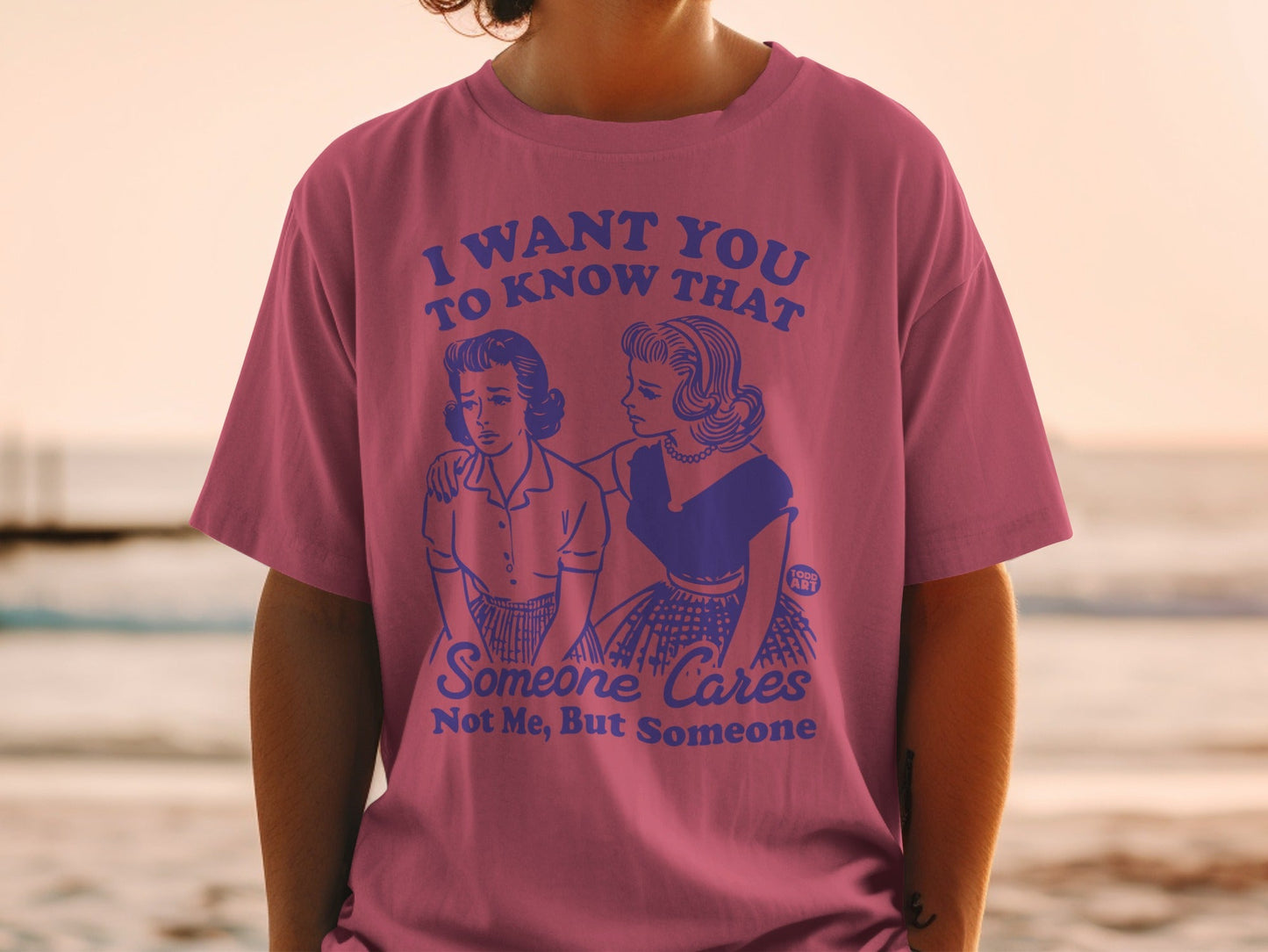 Pink t-shirt with retro illustration and text "Someone Cares Not Me, But Someone".