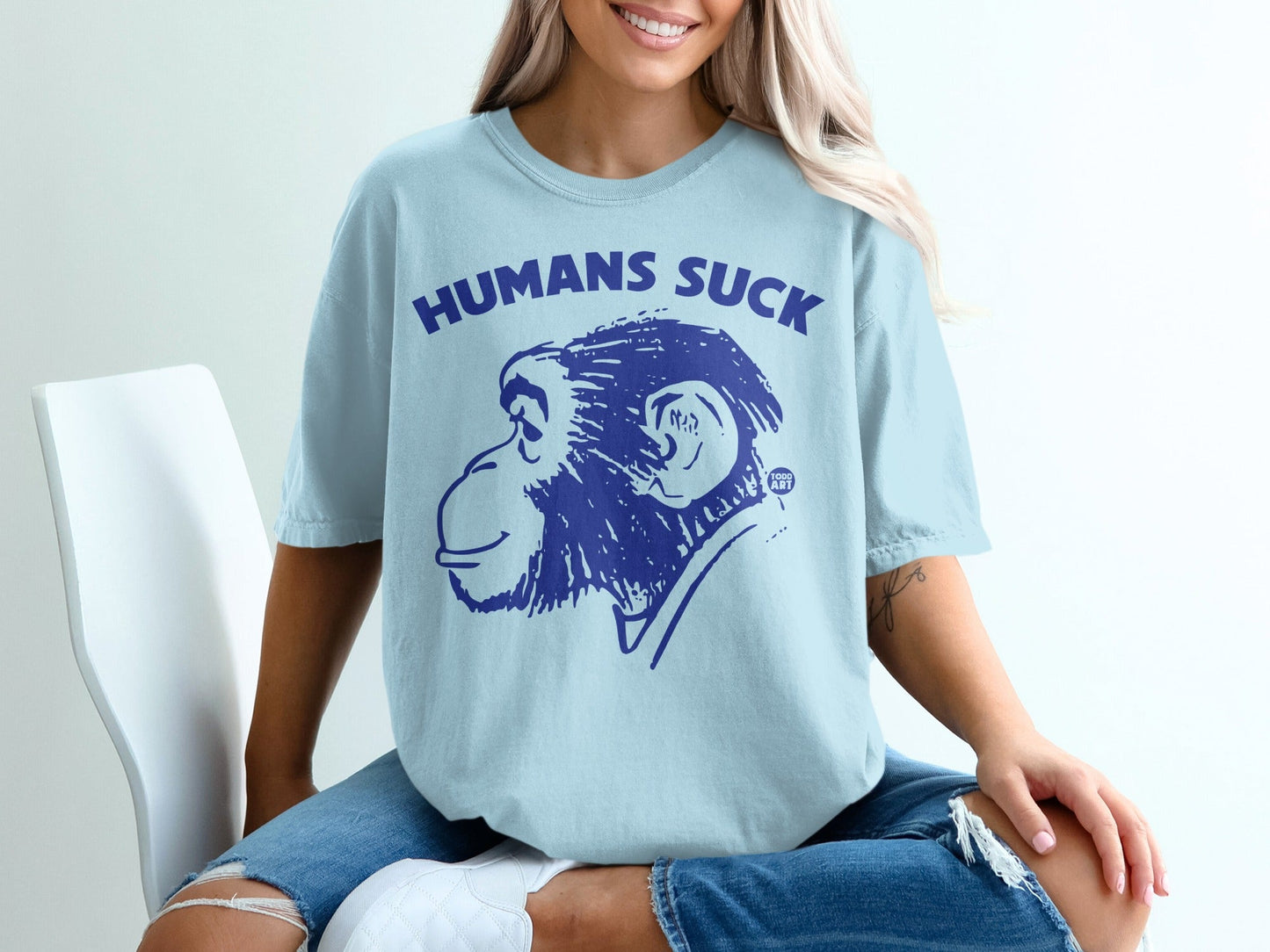Light blue t-shirt with "HUMANS SUCK" and a chimpanzee graphic.