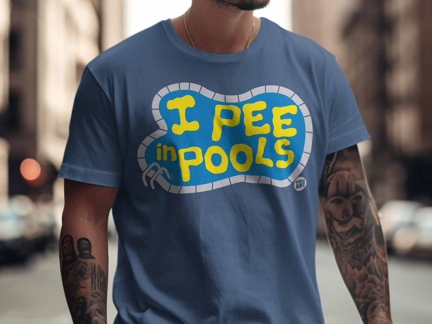 Blue t-shirt with yellow text "I PEE IN POOLS" inside a pool graphic.