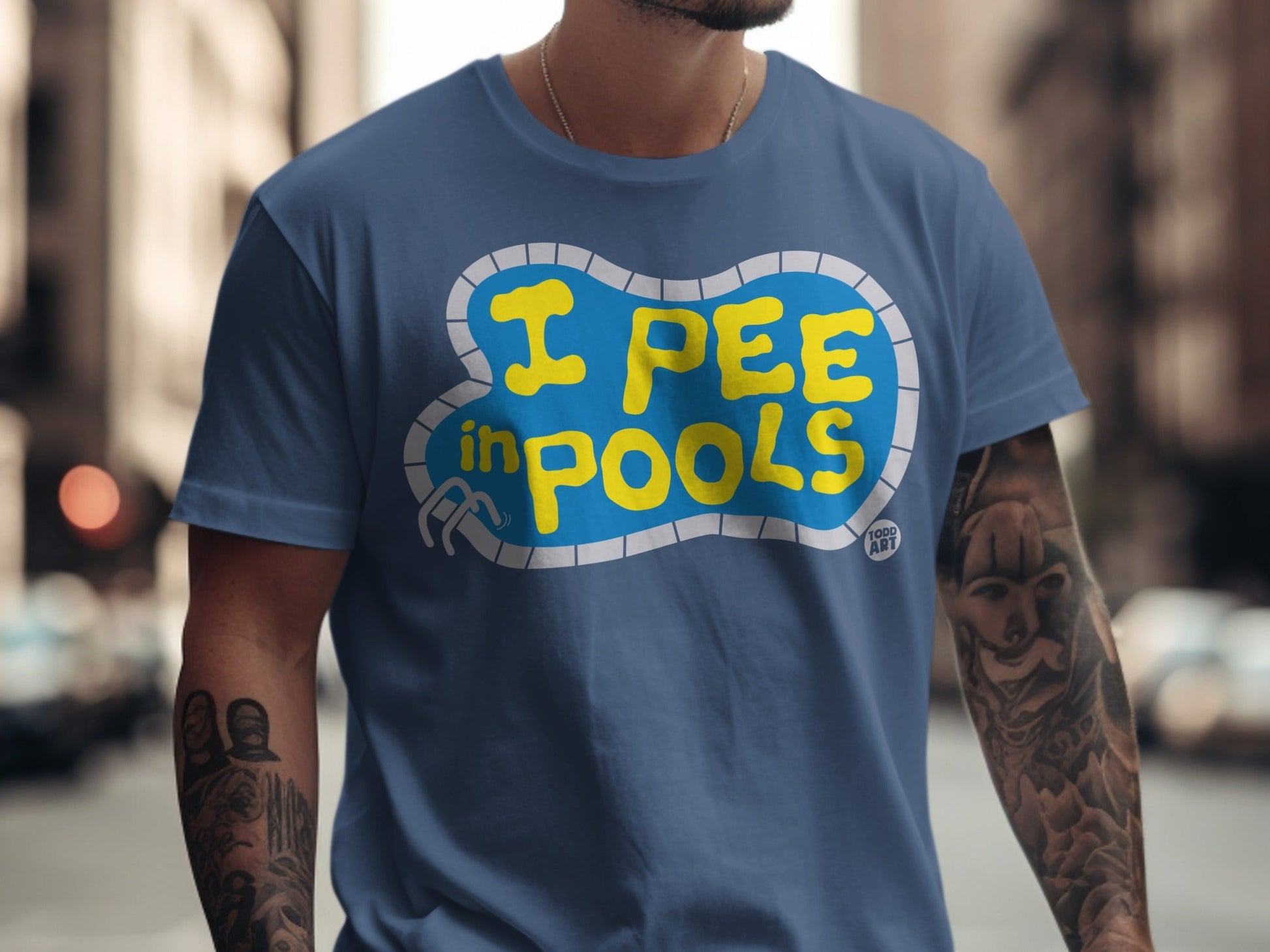 Blue t-shirt with yellow text "I PEE IN POOLS" inside a pool graphic.