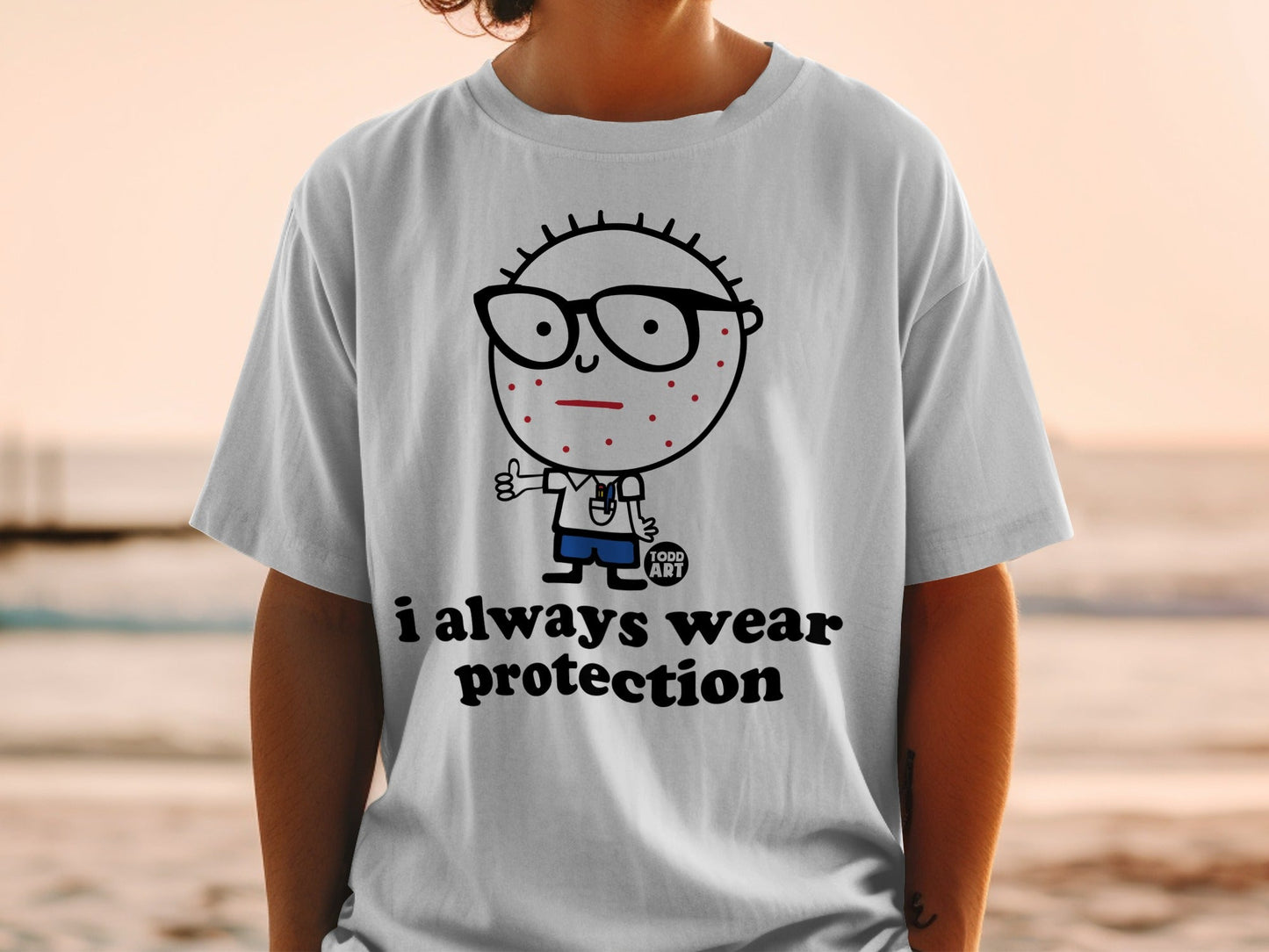 White t-shirt with cartoon character and "i always wear protection" text.