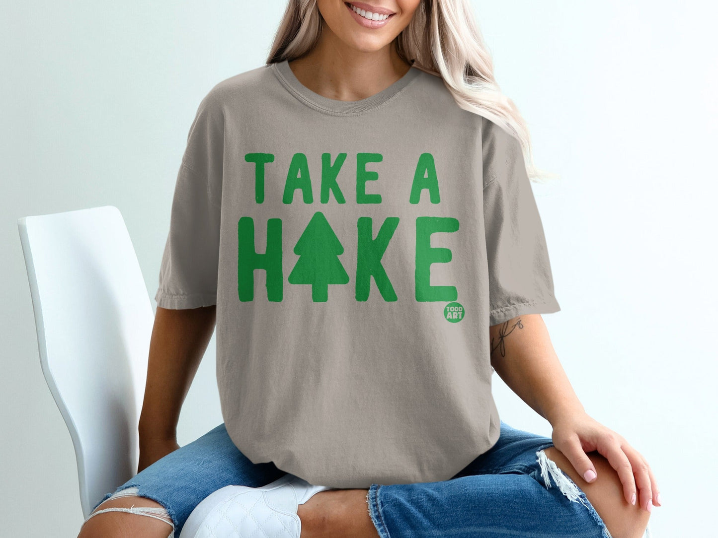 T-shirt with "TAKE A HIKE" text and a tree graphic.