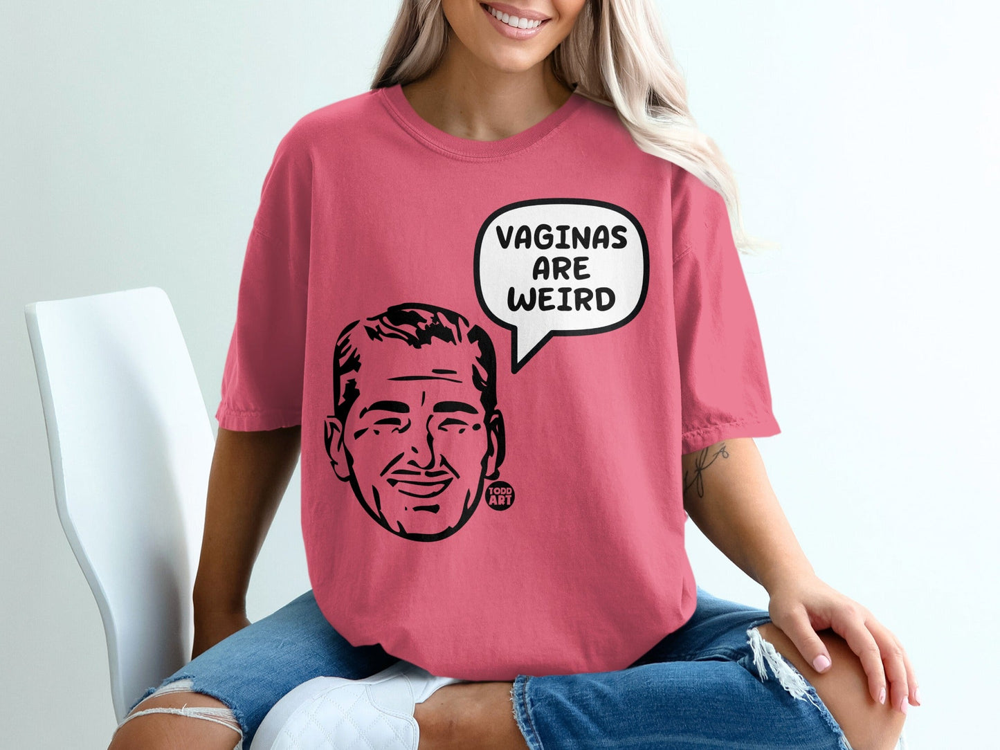 Pink t-shirt with a cartoon man's face and "VAGINAS ARE WEIRD" speech bubble.